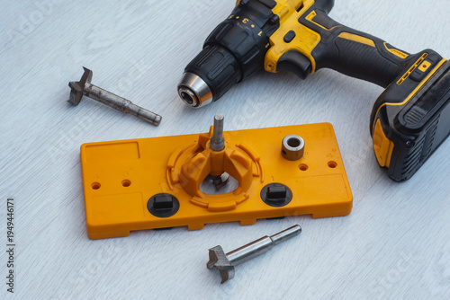 Tableau sur toile Cordless drill with orange cabinet hinge jig and metal boring bits