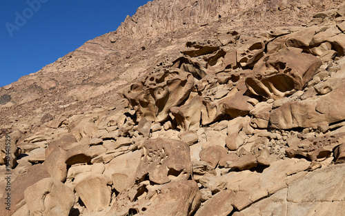 Unusual rock formations in a remote mountain region in the national park Saint Catherine Protectorate in Sinai’s highlands. Patterns and holes on rock walls.