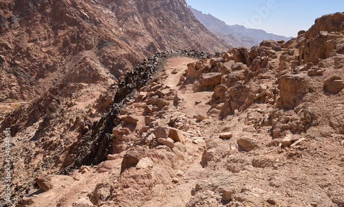 Dramatic landscape of Wadi Muajed or Majid in the national park Saint Katherine Protectorate Sinai. High cliffs and granite walls. Red and black colors of magmatic rock. Dikes.