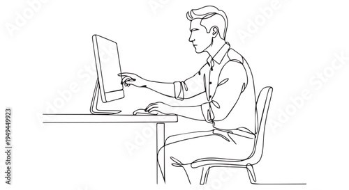 A man sitting at a desk working on a computer in a modern office setting.