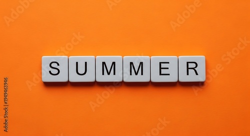 The word summer spelled out in letter tiles on orange background