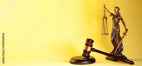 Law theme. Judge's gavel and scales of justice on yellow background.