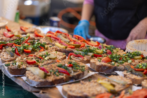 Obraz na plátne Close-up photo of sandwiches with pate and fresh greens served on rye bread at a food stall