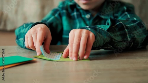Child Hands Folding Note and Inserting Paper into Yellow Envelope on Table — Kid Writing Letter, Sending Handmade Card, Children's Mail and Correspondence Concept Video
