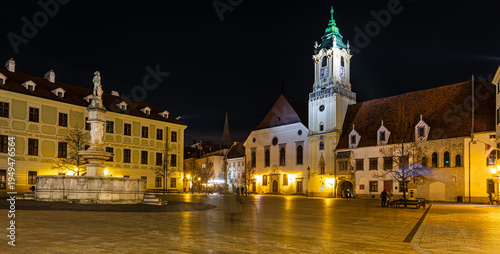 Photography Bratislava Old Town night scene with church tower and glowing street view