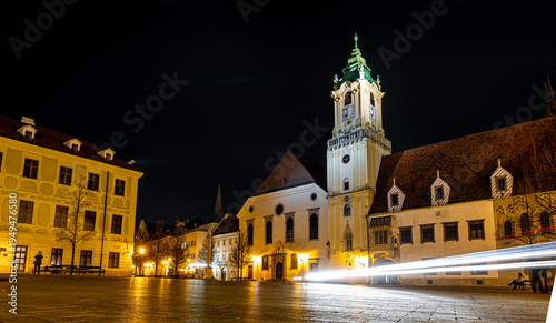 Photography Bratislava Old Town night scene with church tower and glowing street view