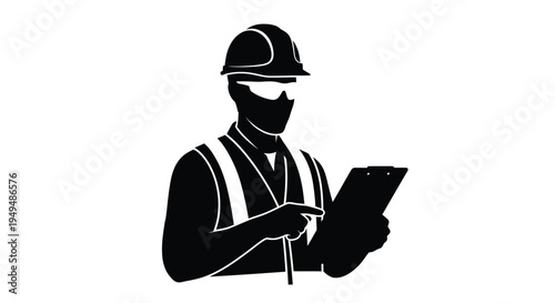 Silhouette of construction worker examining plans on a clipboard