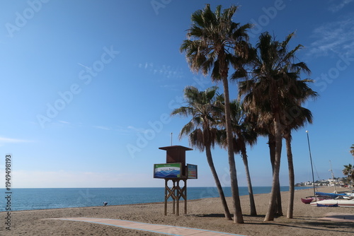 Cuadro en lienzo Lifeguard Watchtower Between Palm Trees on La Cala de Mijas Beach, Costa del Sol
