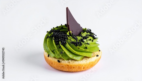 Vibrant green matcha frosting swirls atop a fluffy pastry base, adorned with dark chocolate and black sesame seeds, isolated on a white background