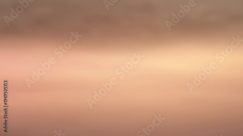 Soft blurred gradient with pale pink and light brown tones creating dreamy atmosphere