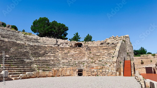 Photograph of the ruins of the ancient Lycian amphitheater, Patara, Turkiye. A historic architectural landmark.