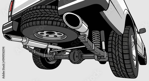 Underside view of a pickup truck chassis with spare tire and exhaust system.