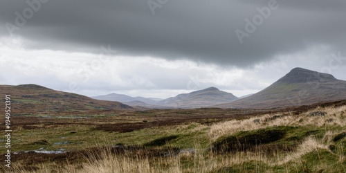 Remote landscape features rolling hills, moorland, cloudy sky. Wet terrain suggests damp climate, peaceful scenery.