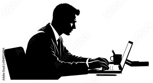 Silhouette of a businessman working on a laptop at a desk in a modern office