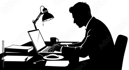 Silhouette of a businessman working on a laptop at a desk in an office