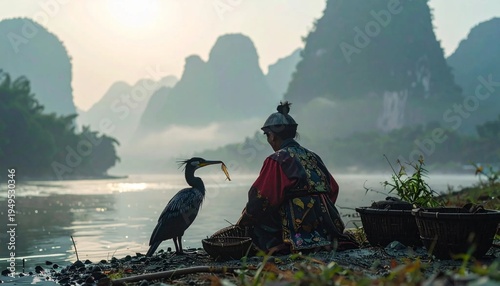 Traditional Cormorant Fisherman and Bird on Li River at Sunrise in Guilin, China.