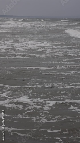 Vertical ocean waves moving and breaking from drone. Vertical aerial ocean waves.