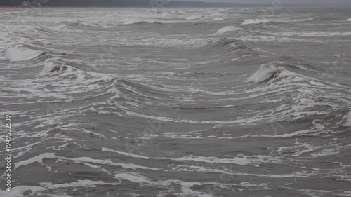Ocean waves moving toward coastline from drone. Aerial waves toward coast.