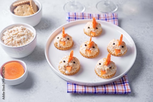 Salmon egg salad with crackers in the form of chicks in the plate for Easter holidays