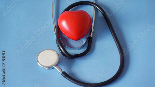 Stethoscope listening to a red heart model for health