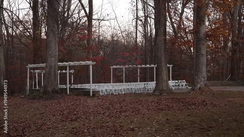 Woodland outdoor wedding ceremony setup in autumn