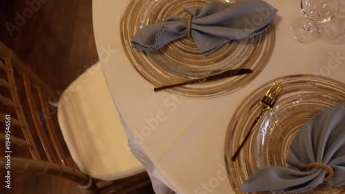 Elegant place setting with blue napkins and woven chargers