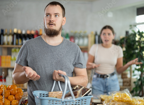Tableau sur toile Wife stands behind husband and yells at companion