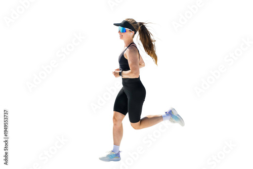Canvas Print Female athlete runs with determination, wearing a black sports bra, biker shorts