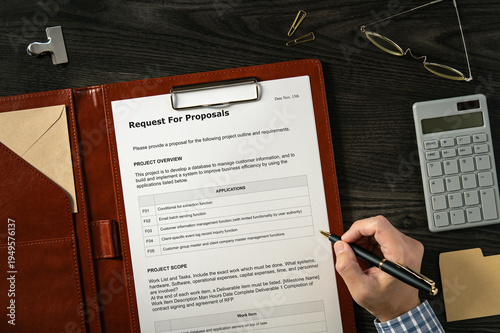Request For Proposal: Realistic mock-up mock placed on  with calculator, glasses, pen. Contributor-created fictional business document for illustrative purposes.