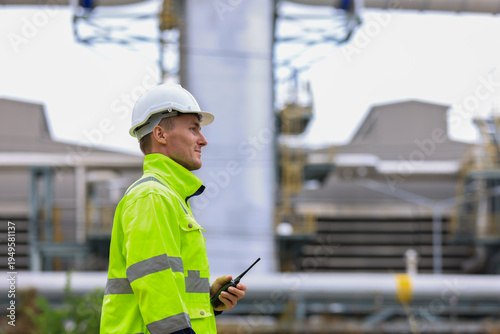 Industrial Engineer Using Digital Tablet for Predictive Maintenance in Oil and Gas Refinery. Team of Engineers Discussing Safety Protocols at Large Scale Oil Refinery Facility.