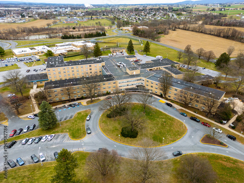 Aerial drone view of a large building facility on a cloudy day. 
