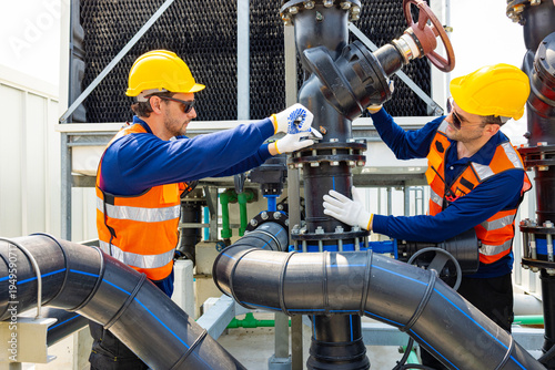 Industrial Technicians Adjusting Large Pipeline Valve