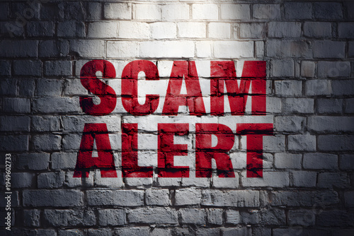 Scam alert warning sign on wall.
