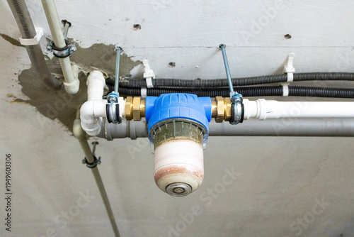 Dirty water filter cartridge in plumbing system showing sediment buildup