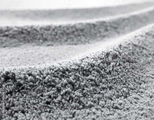 Close-up view of a plush grey carpet with soft texture and gentle curves.