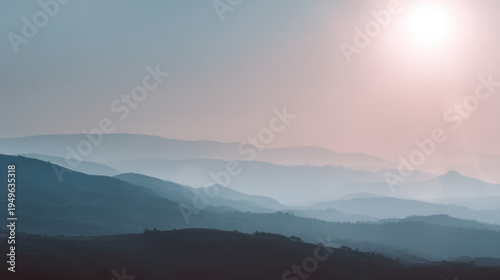 Misty mountain soft pastel sky sunrise light distant hill atmospheric depth serene landscape minimal nature scene with dreamy
