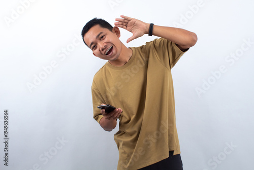 Man with Mobile Phone and Hearing Gesture on White Background