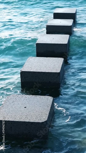 Stone blocks create a path across the rippling water surface