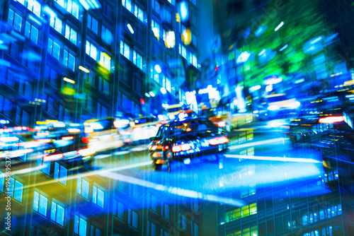 Multiple exposure of Tokyo business district at night, representing the dizzying pace of city life.