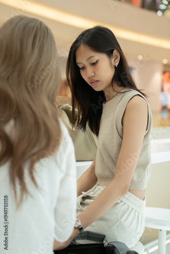 Free Download Young asian women friends having a casual conversation - GFXLoad
