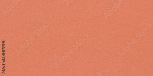Close-up view of a textured peach-colored fabric surface with subtle graininess