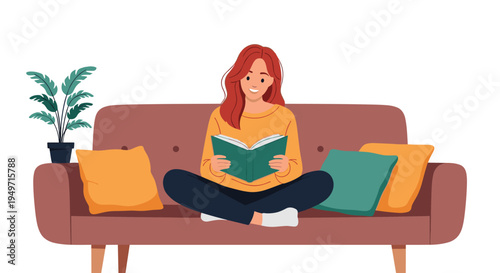 Young woman sitting cross-legged on a cozy brown sofa reading a green book in a relaxed home environment with a houseplant nearby.
