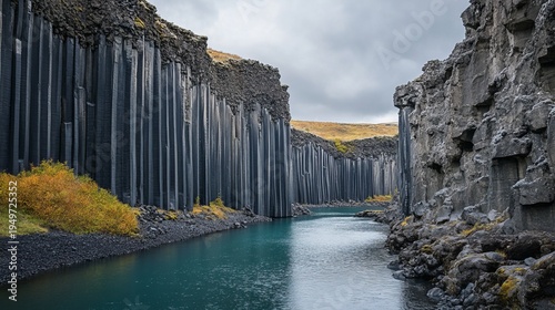 Breathtaking aerial view of studlagil basalt canyon in iceland with dramatic cliffs and flowing river