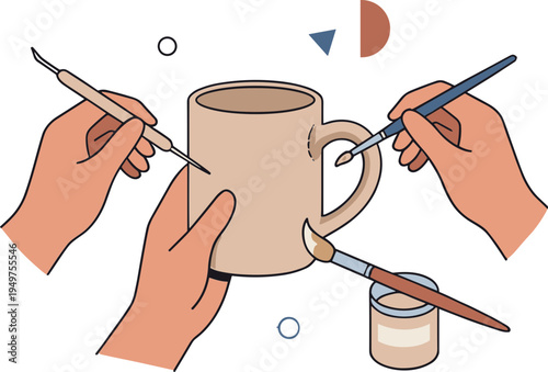 Hands painting a ceramic mug with brushes and paint