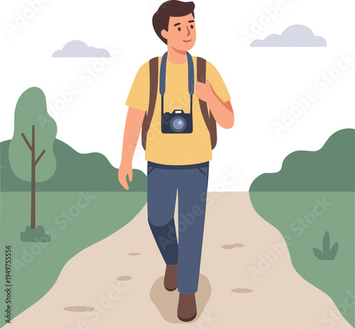 Man walking on a path with a camera around his neck in a park