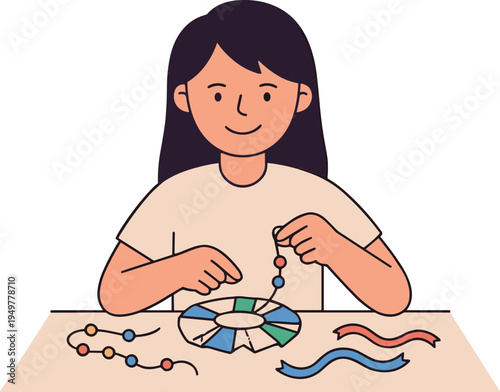 A young girl sitting at a table threading beads onto strings with a smiling face and long dark hair.