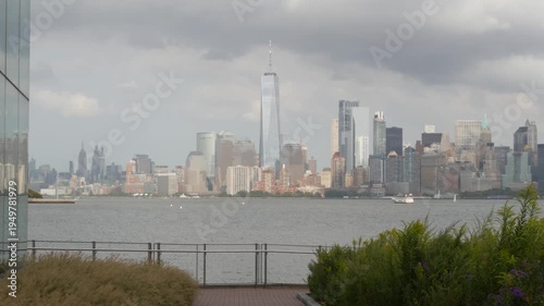 New York City Manhattan Downtown skyline from Liberty Island, United States. Financial District cityscape, World Trade Center skyscraper tower. Building architecture. Rainy cloudy autumn fall weather.