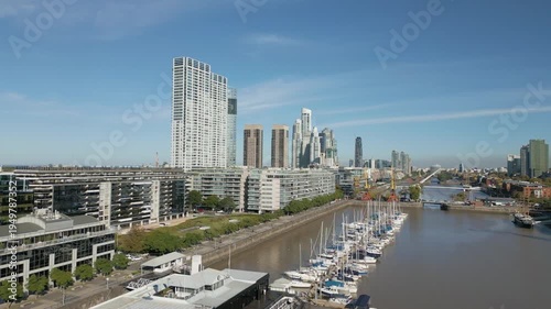 Views of the waterfront area in the city with buildings and boats in daylight
