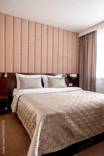 Quadro su tela neatly made double bed with pillows and beige blanket in modern hotel bedroom in