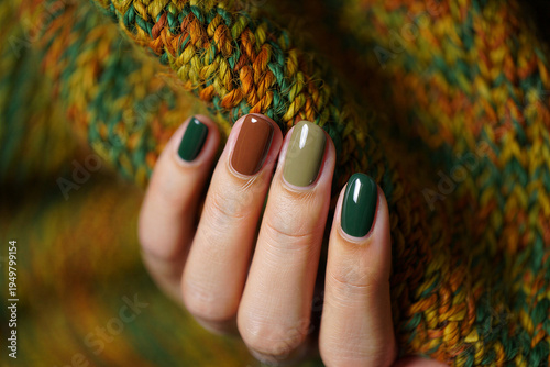 Hand with multicolored nail polish on knitted sweater closeup shot transparent background